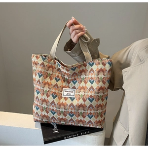 Detail of bohemian canvas tote bag with geometric jacquard pattern and woven handle
