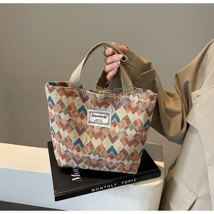 Detail of bohemian geometric rhombus pattern on high-capacity canvas tote bag
