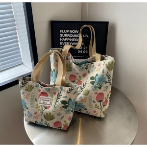 Detail of floral woven texture and branded label on these high-capacity canvas tote bags