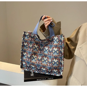 Close-up of geometric jacquard pattern and durable woven handles on the tote bag