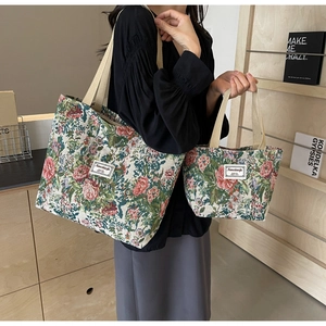 Macro view of floral pattern vintage canvas tote bag set with branded woven label