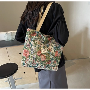 Detailed macro view of vintage floral tapestry tote bag with cotton web straps