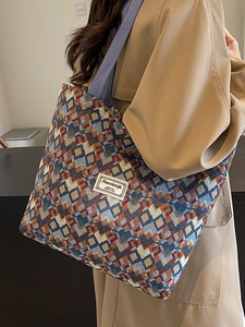 Bohemian geometric woven tote bag with colorful diamond patterns and wide shoulder strap