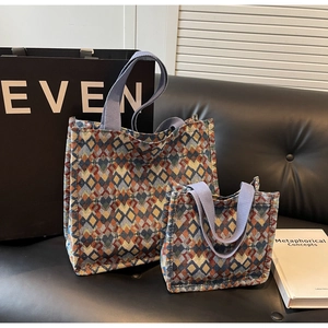 Detail view of woven jacquard tote bags with blue and orange geometric diamond patterns