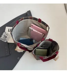 Interior view of checkered tote bags showing spacious compartments with everyday essentials