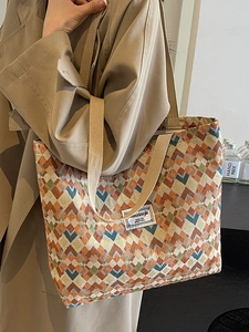 Bohemian woven tote bag with colorful geometric patterns and comfortable shoulder strap
