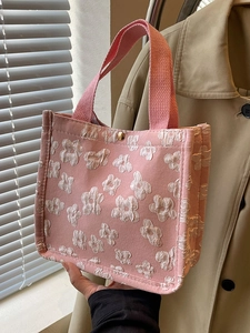 Pink canvas tote bag with 3D white floral patterns and braided top handles for women