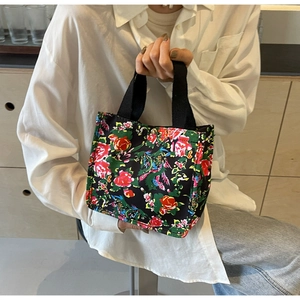 Detail shot of vintage floral pattern on large tote bag with metallic snap closure