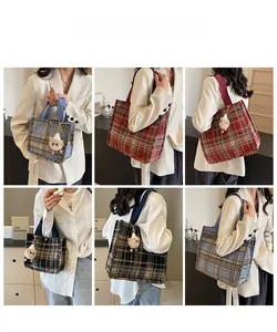 Detail view of various plaid wool tote bags with plush sheep charms in multiple colors