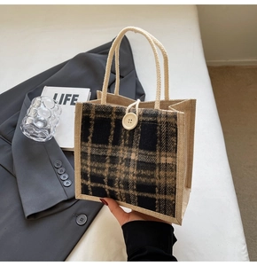 Detail of checkered linen handbag with braided rope handle and round button closure
