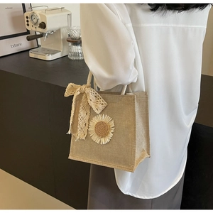Detail of jute tote bag with 3D sunflower and lace bow in a lifestyle setting