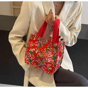 Detailed macro shot of vintage floral canvas tote bag with magnetic metal buckle closure