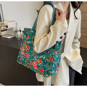 Green vintage floral tote bag with large capacity shown in a cozy cafe setting