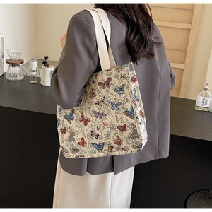 Detailed view of vintage butterfly jacquard weave on a large canvas tote bag