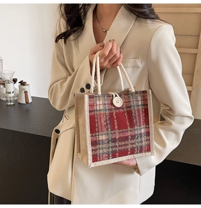 Close-up of linen tote bag with red tartan panel and decorative white button closure