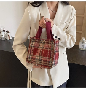 Detail of red Scottish plaid wool tote bag with durable burgundy webbing handles