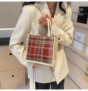 Detail of red plaid tweed handbag with woven cotton rope handles for winter style