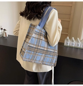 Detail of the blue and brown plaid wool tote bag with a comfortable woven shoulder strap