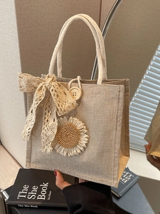 Handmade woven tote bag with 3D sunflower and lace bow in a warm rustic style