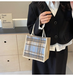 Close-up of portable linen tote bag with blue plaid patterns and rope handles
