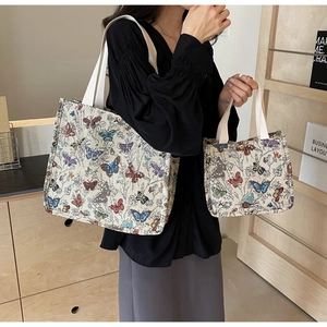 Detail of two-piece set canvas tote bags featuring colorful butterfly print patterns