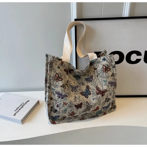 Detail of artistic butterfly jacquard fabric and cotton webbing handles on large tote bag