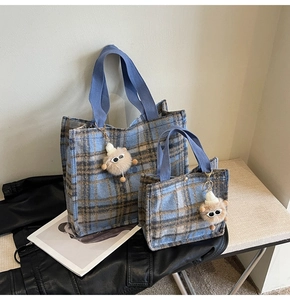 Detail of blue plaid wool tote bag set featuring cute plush charms and durable handles
