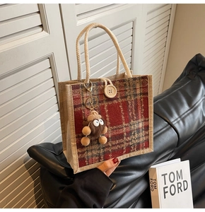 Linen tote bag with red plaid patch, cream woven handles, and cute brown plush charm