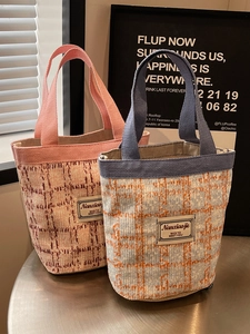 Fashionable woven linen bucket handbag featuring thick tweed fabric in pink and blue colors