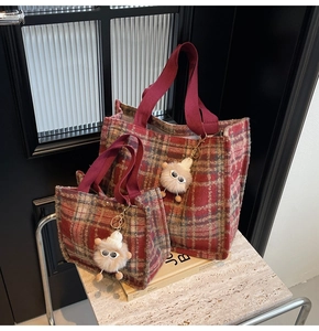 Detail of red plaid wool tote bags in two sizes with cute fuzzy monster charm accessories