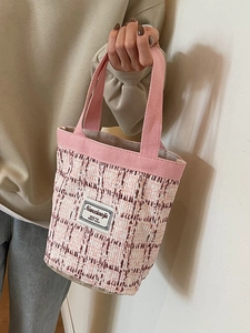 Pink checkered linen bucket bag with woven handles and minimalist text label