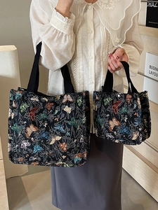 Set of two black canvas tote bags with colorful butterfly floral jacquard patterns