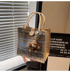 Detail of blue plaid linen tote bag with large white button and rope handle