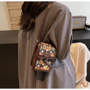 Detail of vintage bohemian crossbody bag featuring colorful woven geometric patterns
