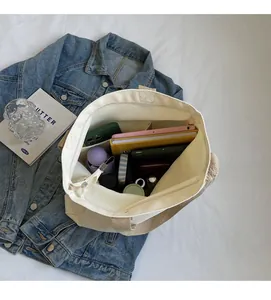 Top view of spacious canvas tote interior with organized compartments for daily essentials