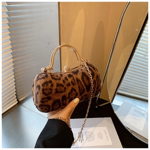 Detailed view of leopard print clutch with rhinestone top handle and metal ball lock