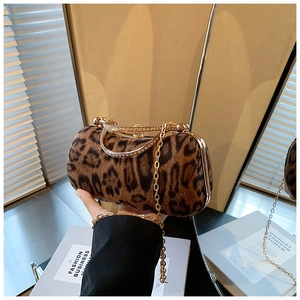Detailed view of leopard print clutch featuring gold hardware and sparkling crystal clasp