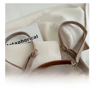 Detailed shot of comfortable leather strap and gold buckles on a vintage khaki wool handbag