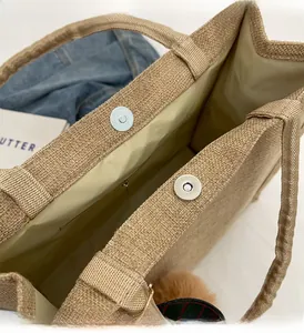 Close-up of linen tote bag featuring secure double magnetic snap closure and soft lining