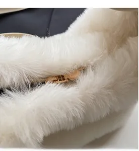 Close-up of smooth gold metal zipper on premium white plush handbag for women