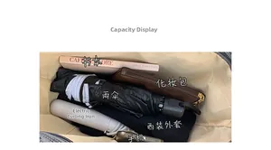 Spacious interior of a large tote bag holding books, umbrella, and essentials
