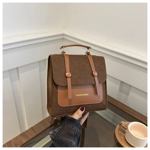 Detail of vintage brown felt handbag with leather patch and 'FASHION & BAGS' text