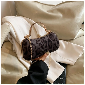 Close-up of leopard print velvet evening bag with gold metal handle and chain strap