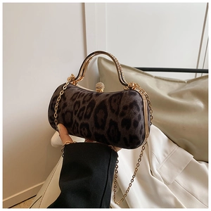 Detail of leopard print evening bag with golden metal handle and rhinestone clasp