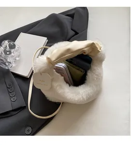 Detailed view of the white plush handbag interior showing large storage capacity and texture