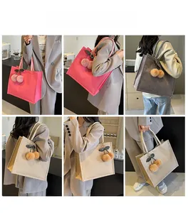 Linen tote bag for students shown in pink, grey, and beige with cherry pendant charm