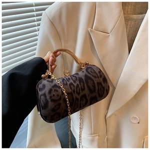 Close-up of leopard print evening clutch with gold handle and sparkling crystal clasp