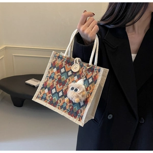 Detail of linen tote bag with colorful geometric patterns and cotton rope handles