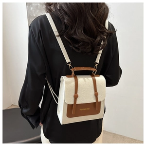 Detail view of felt and PU leather mini backpack with contrast trim and logo on model back
