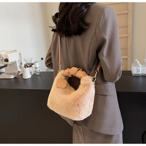 Detail of plush faux fur shoulder bag with scrunchie handle and adjustable strap